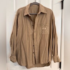 Reworked flannel with smiley face stitched on pocket